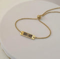 Pulsera Esclava Dorada con Placa Personalizada